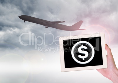 Airplane and dollar icon on tablet in hand