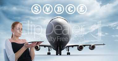 Currency icons and plane with woman holding tablet