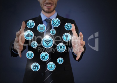 Businessman with hands palm open and various business icons