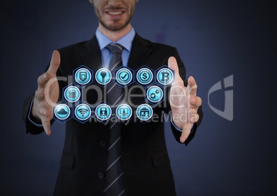 Businessman with hands palm open and various business icons