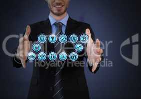 Businessman with hands palm open and various business icons