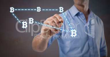 Businessman holding pen with bitcoin graphic icons connecting