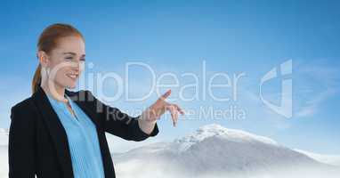 Businesswoman touching air with snow mountains