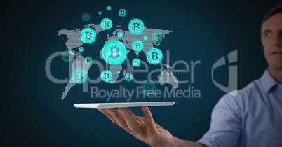 Bitcoin icons on world map with man holding tablet