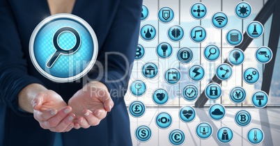 Magnifying glass search icon with various apps and Businesswoman with hand palm open in city office