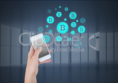 Bitcoin icons and hand holding phone