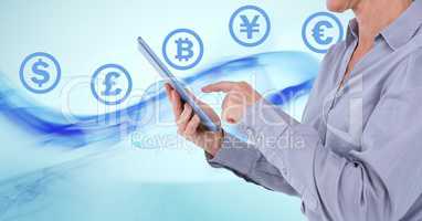 Currency icons and hands holding tablet