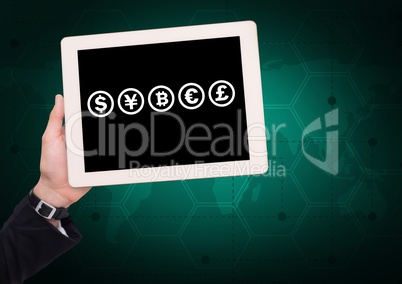 Currency icons on tablet in hand over world map