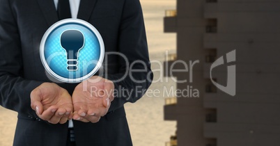 Light bulb icon and Businessman with hands palm open in city