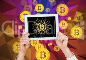 Bitcoin icons and hands holding tablet