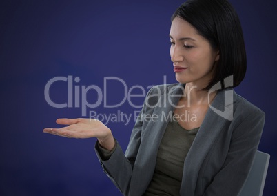 Businesswoman with hands palm open and dark background