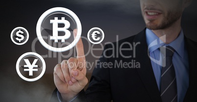 Businessman touching bitcoin graphic icon with currencies