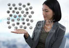 Various app icons and Businesswoman with hand palm open in city office