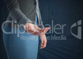 Businesswoman with hand palm open and dark background