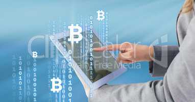 Bitcoin icons and interface on tablet in woman's hands