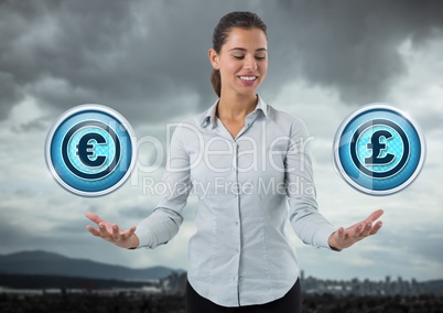 Euro and Pound icons and Businesswoman with hands palm open in city landscape and sky