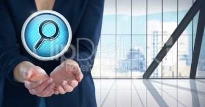 Magnifying glass search icon and Businesswoman with hand palm open in city office