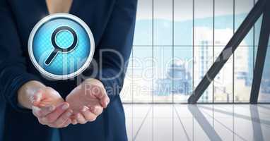 Magnifying glass search icon and Businesswoman with hand palm open in city office