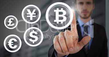 Businessman touching bitcoin graphic icon with international money currency