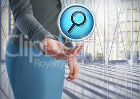Magnifying glass search icon and Businesswoman with hand palm open in city office