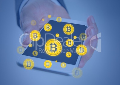 Bitcoin icons and hand holding phone