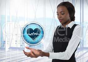 Heart pulse icon and Businesswoman with hands palm open in city office
