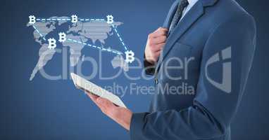 Bitcoin network on world map with businessman holding tablet
