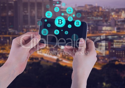 Bitcoin icons and hands holding phone