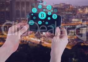 Bitcoin icons and hands holding phone