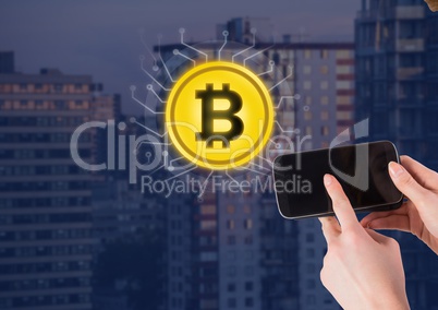 Bitcoin icon next to hand holding phone