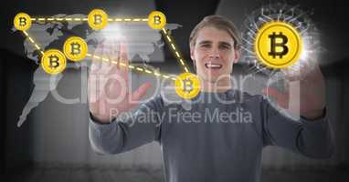 Businessman holding hands up in front of bitcoin graphic icons and world map