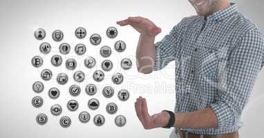 Various app icons and Businessman with hands palm open in city