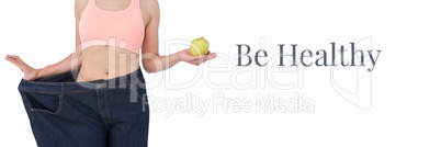 Be healthy text and fit woman holding apple in oversized trousers
