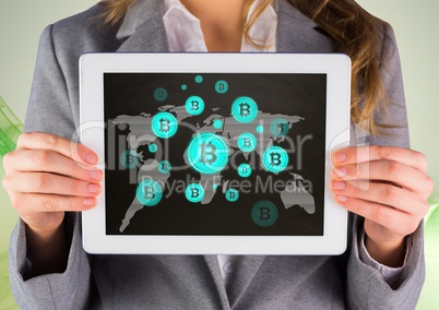 Bitcoin icons on world map and woman holding tablet