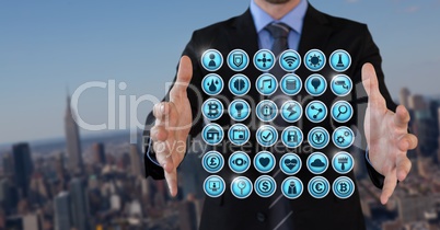Various app icons and Businessman with hands palm open in city
