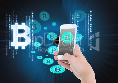 Bitcoin icons and hand holding phone