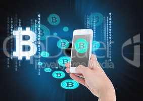 Bitcoin icons and hand holding phone