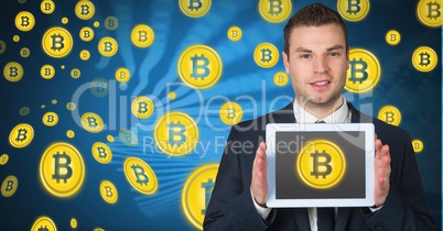 Bitcoin icons and man holding tablet