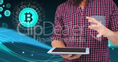 Bitcoin icons and man holding tablet
