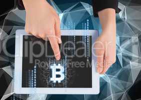 Bitcoin icon and interface on tablet in hands
