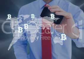 Bitcoin icons on world map and man holding phone