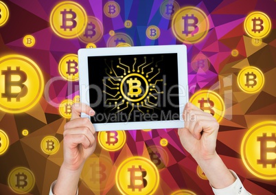 Bitcoin icons and hands holding tablet