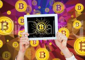 Bitcoin icons and hands holding tablet