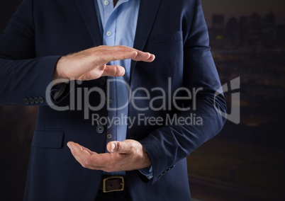 Businessman with hands palm open and dark background