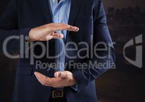 Businessman with hands palm open and dark background