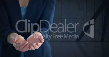 Businesswoman with hand palm open and dark background