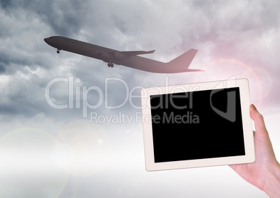 Airplane and tablet in hand