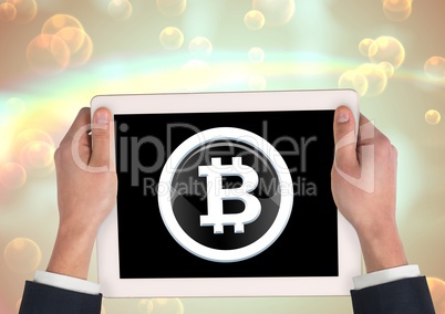 Bitcoin glass circle icon on tablet in hands