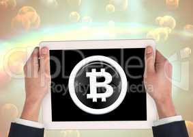 Bitcoin glass circle icon on tablet in hands