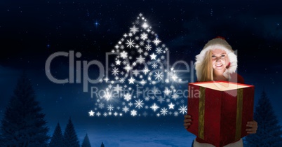 Woman Santa holding magical gift and Snowflake Christmas tree pattern shape glowing in Winter night